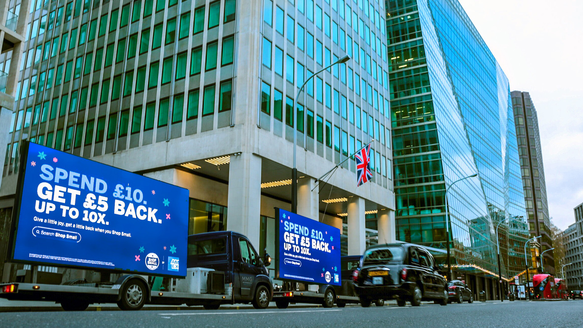 American Express Digivan convoy of 2 in a business district