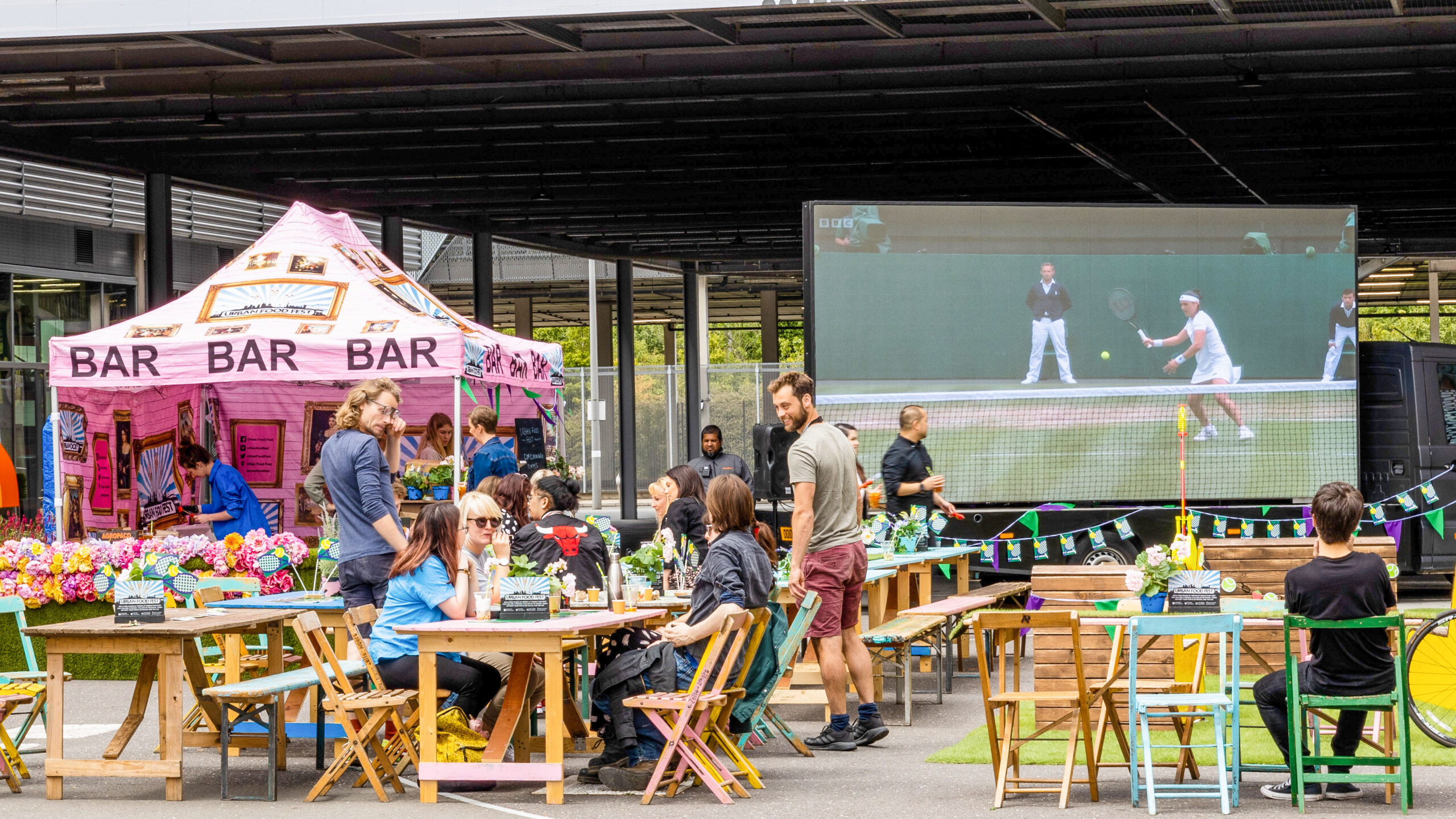 People watching tennis in outside event space