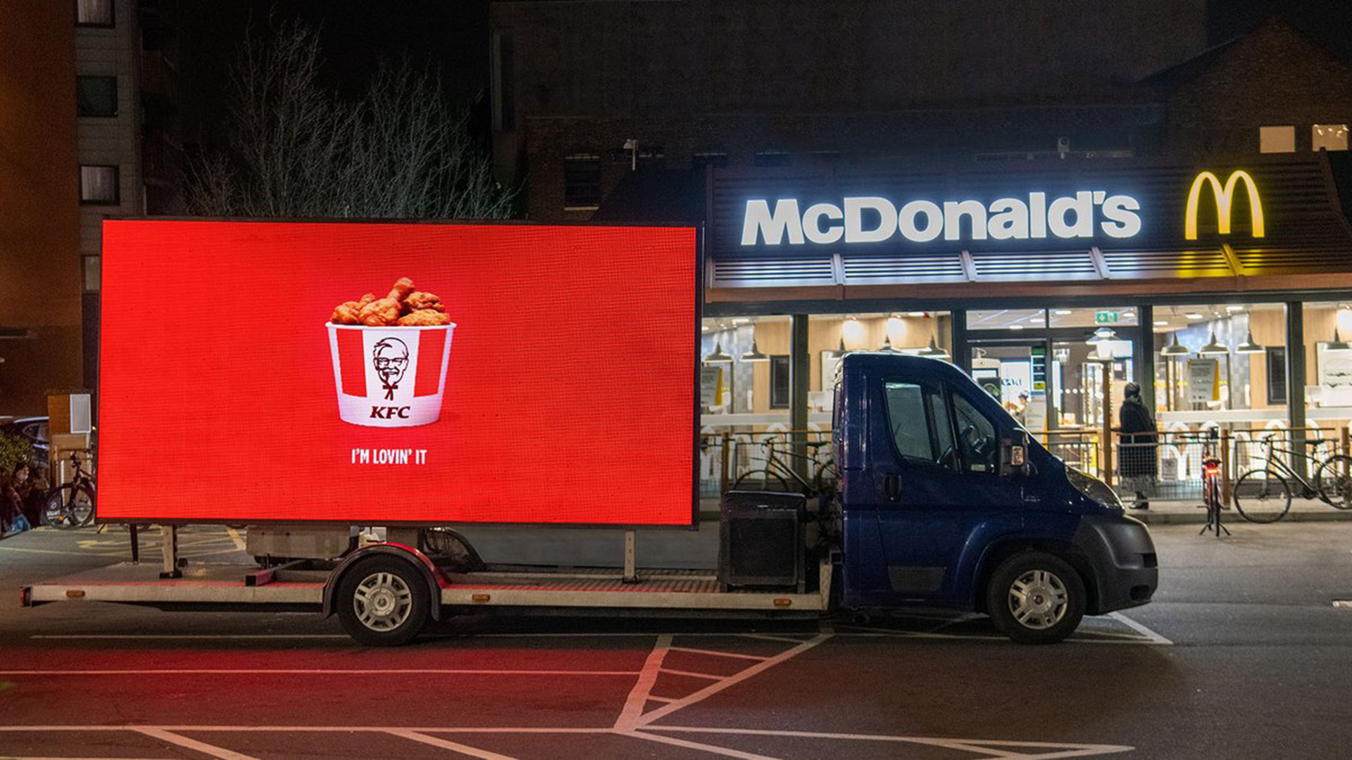 KFC PR Digivan outside of a McDonalds at night
