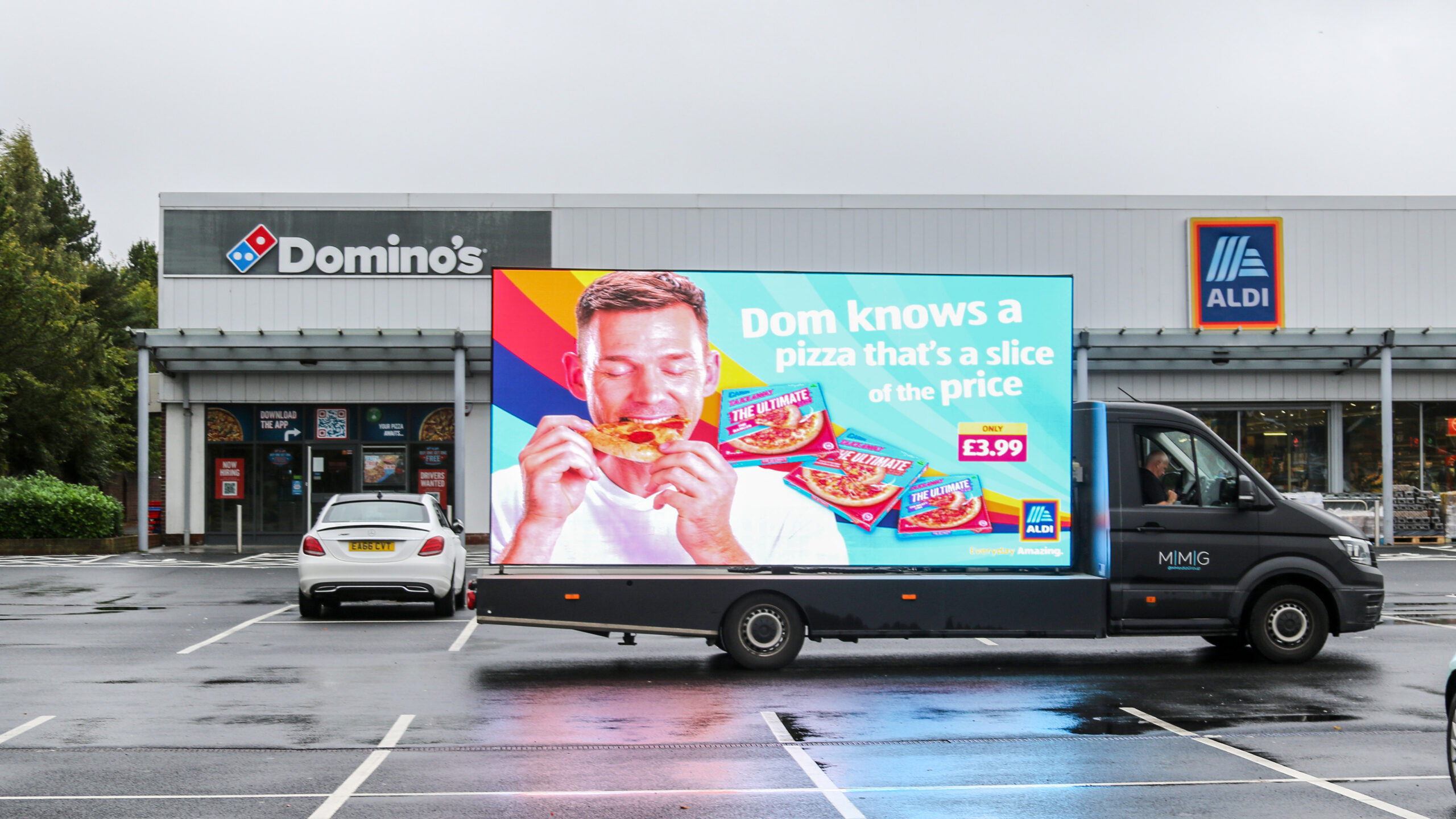 Digivan outside Dominos and Aldi with contextual creative