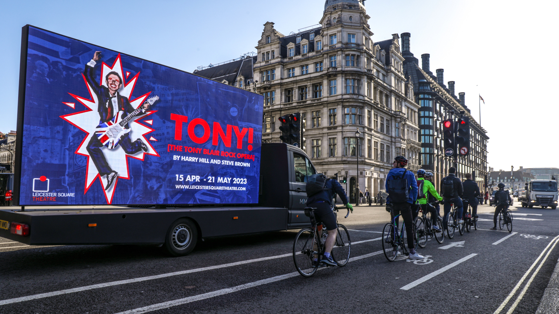 Cyclists looking at Digivan screen in London